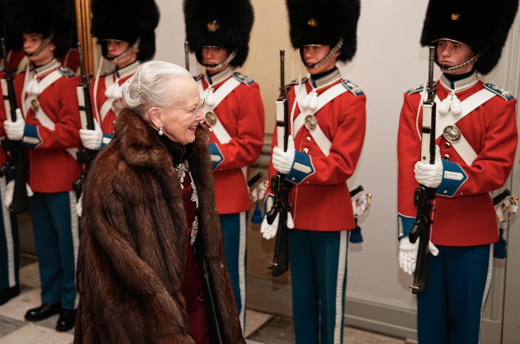 Queen Margrethe reviews an honour guard 