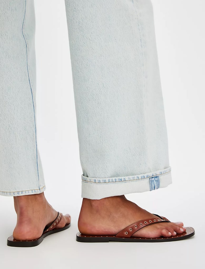 A model wears brown flip flops 