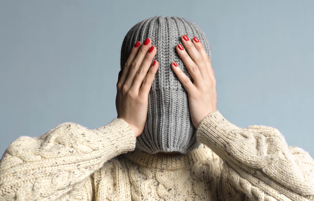 HIDING UNDER A HAT AWAY FROM THE WORLD