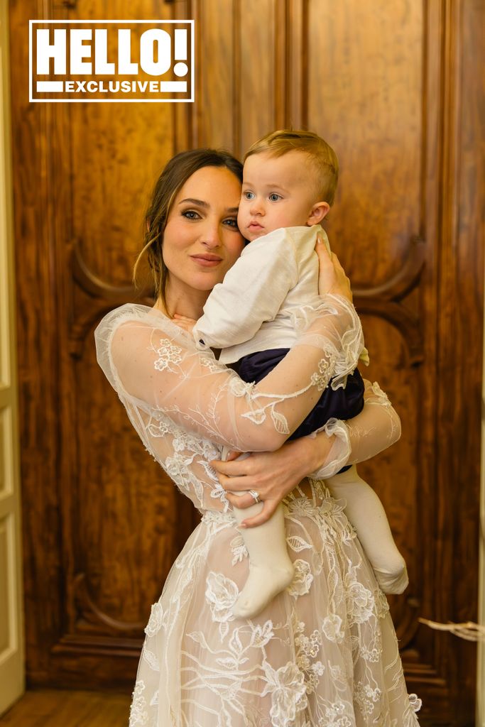 Maeva D'Ascanio wearing tulle and lace wedding dress holding son Beau