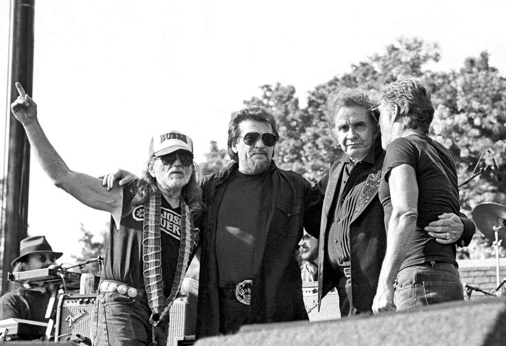 American country music group the Highwaymen, from left, Willie Nelson, Waylon Jennings, Johnny Cash, and Kris Kristofferson, embrace onstage at Central Park Summer Stage, in 1993.