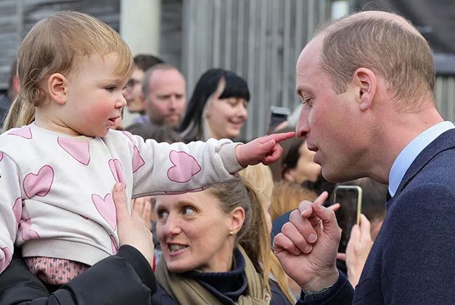 prince william pointing at baby