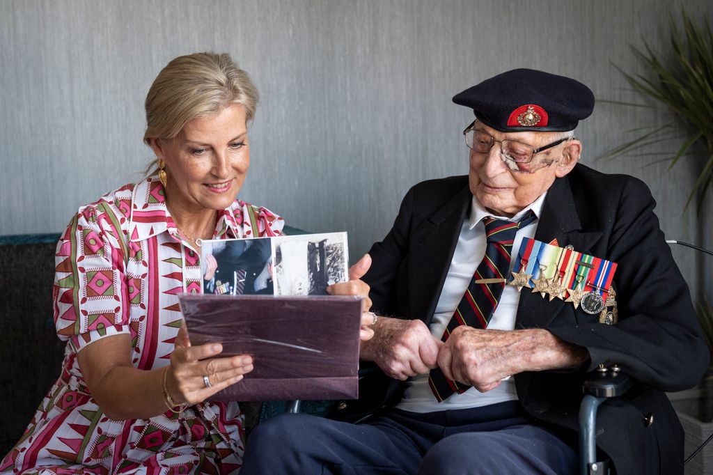 Sophie, Duchess of Edinburgh, patron of the Java Far East Prisoner of War Club 1942, views photographs with 105-year-old Royal Marines veteran James 'Jim' Wren