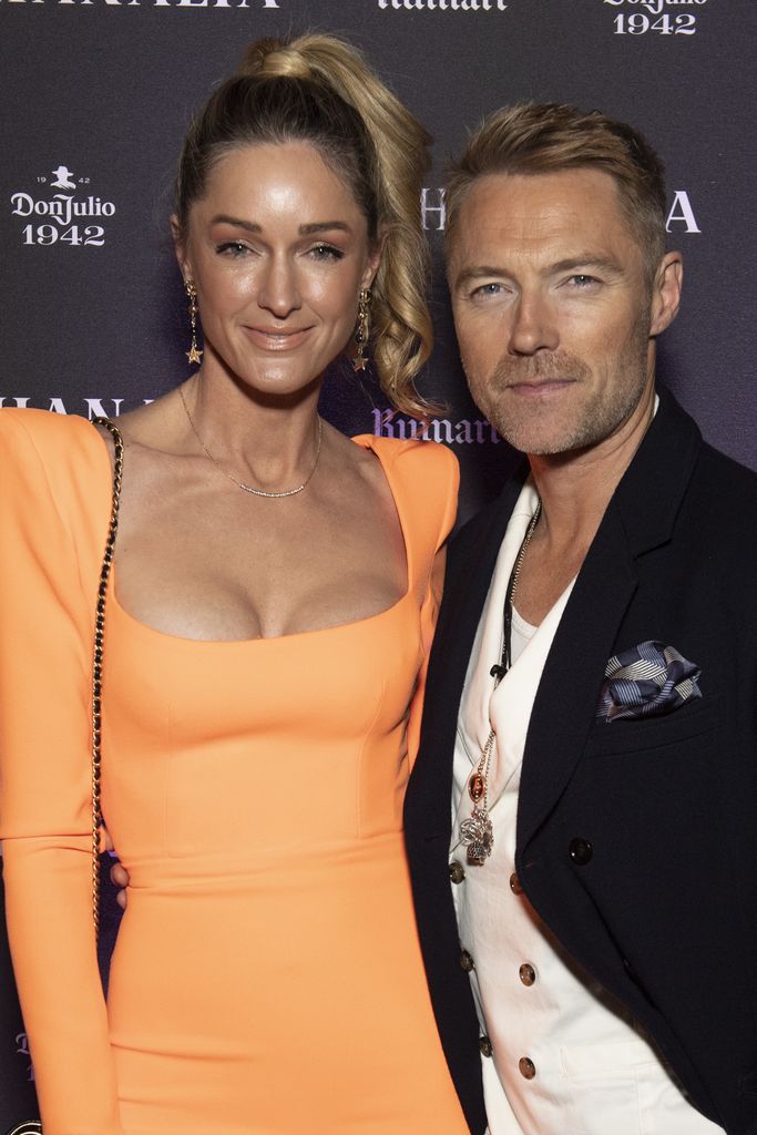 Storm Keating and Ronan Keating pose on red carpet at Bacchanalia's Grand Opening Party 
