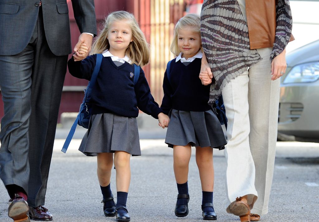 A young Princess Leonor holding Infanta Sofia's hand