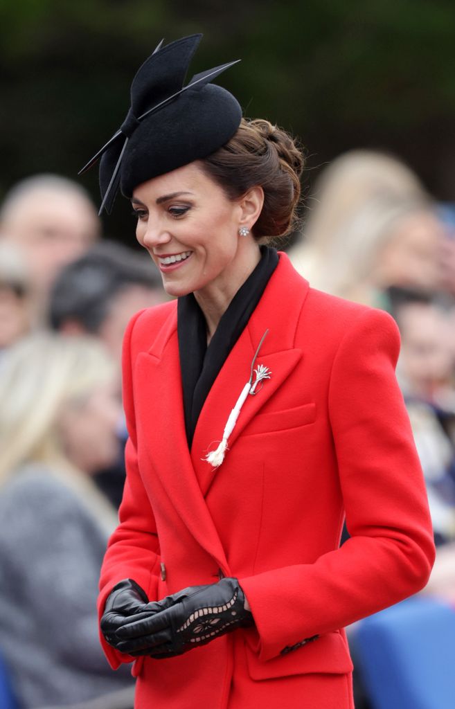 The Princess of Wales in red coat with black hat and gloves