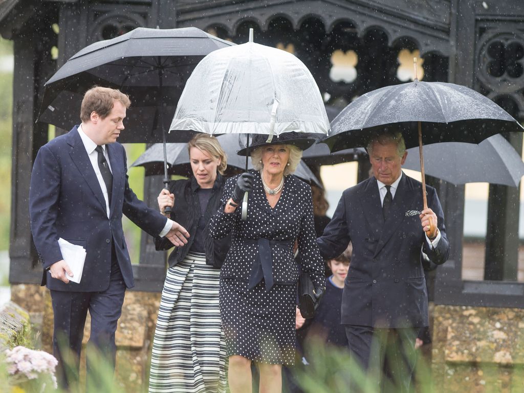 King Charles queen camilla and her children walking in the rain