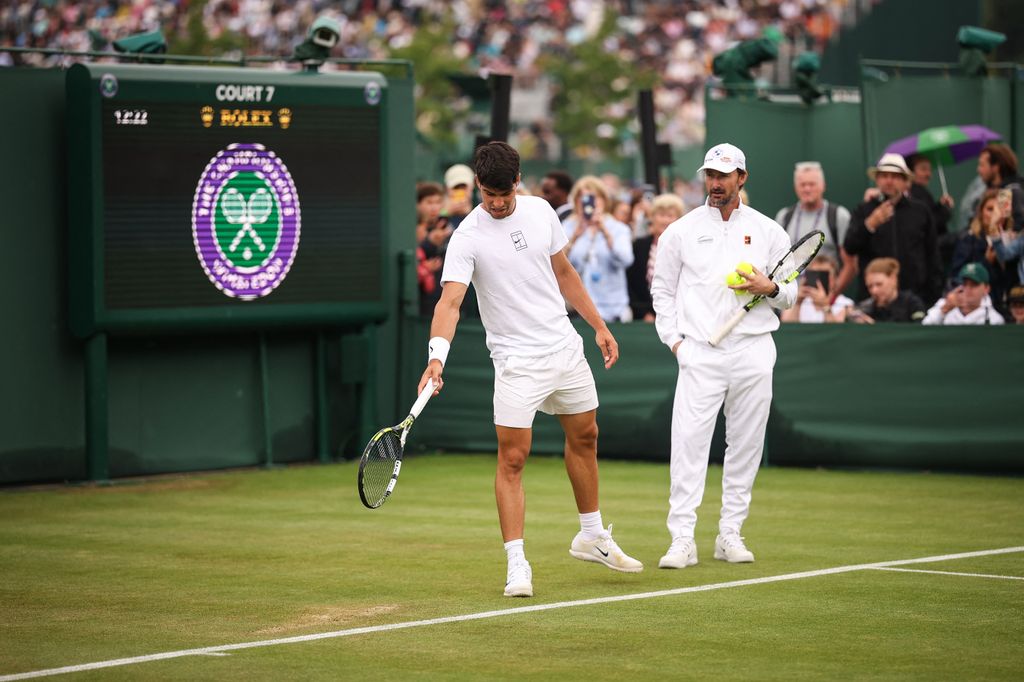 Spain's Carlos Alcaraz trains with his coach Juan Carlos Ferrero on court 7 ahead of his men's singles second round tennis match