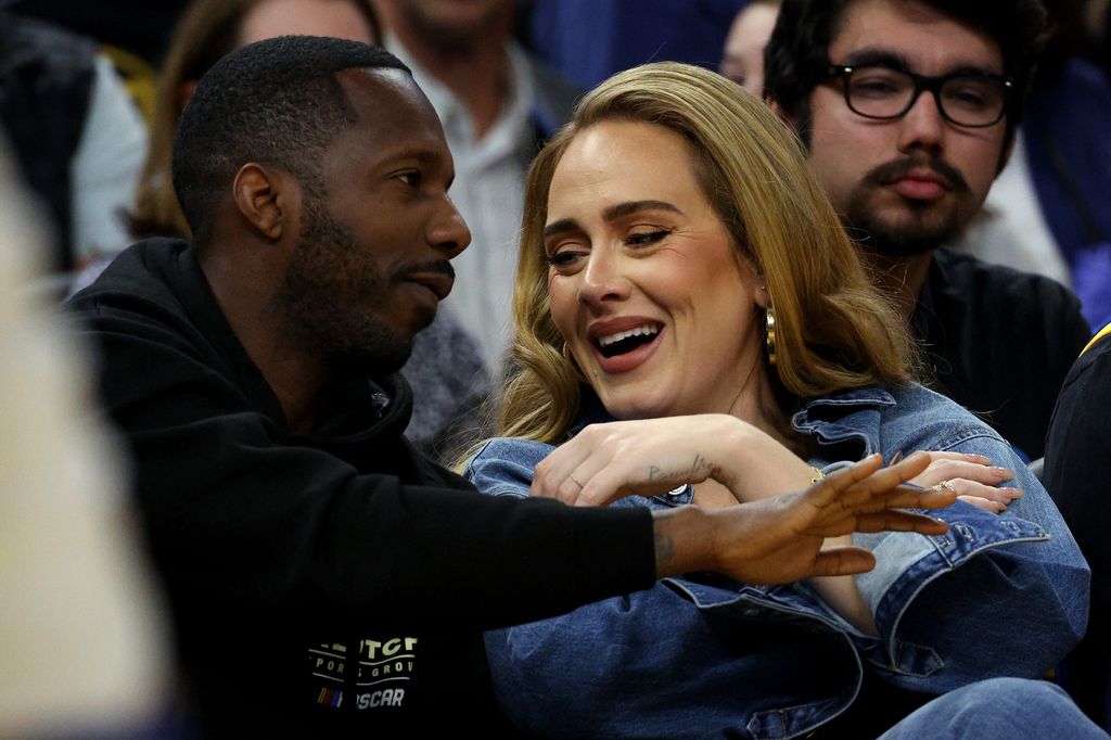 The couple smiling while attending a basketball game together