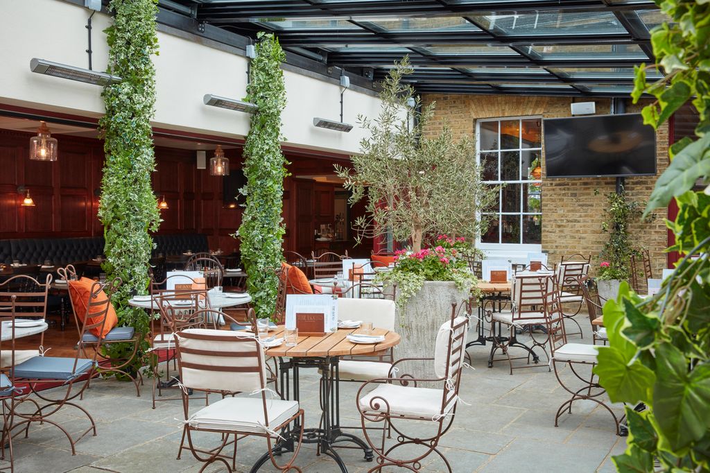 outside restaurant courtyard with tables and greenery