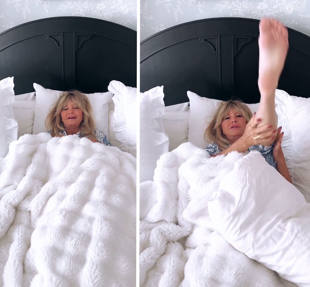 Goldie Hawn lies in her bed and stretches a leg