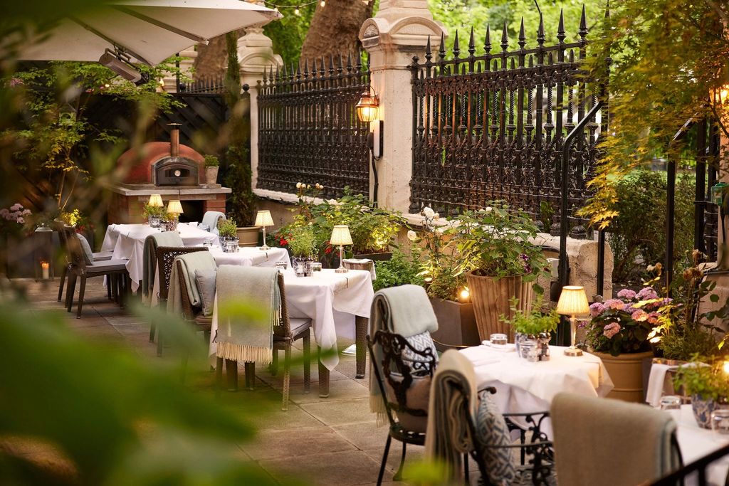 outside restaurant tables beside high metal fence