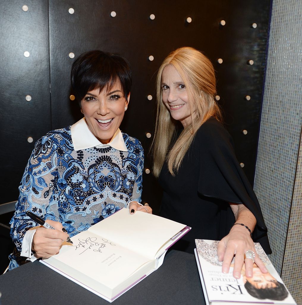 Cici Bussey and Kris Jenner smiling with copies of Kris' book