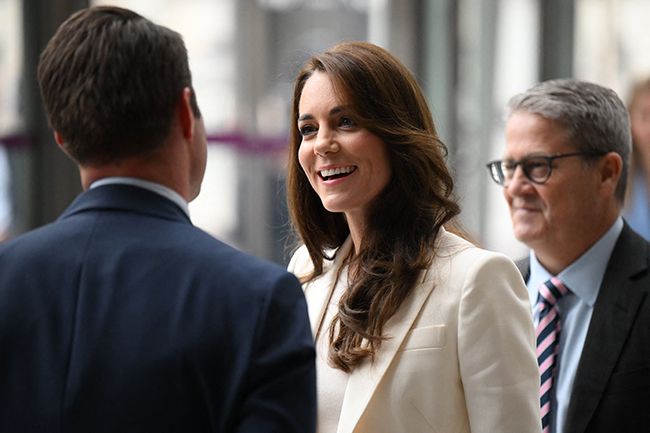 kate middleton smiles as she talks with guests at business task force meeting