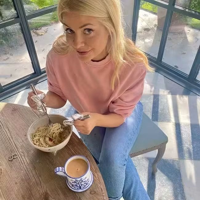 holly willoughby sitting eating at dining table at home