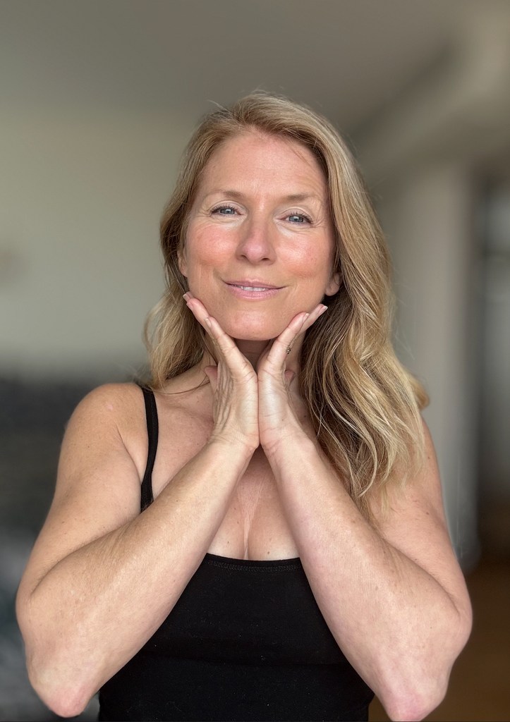 woman looking fresh holding her face 