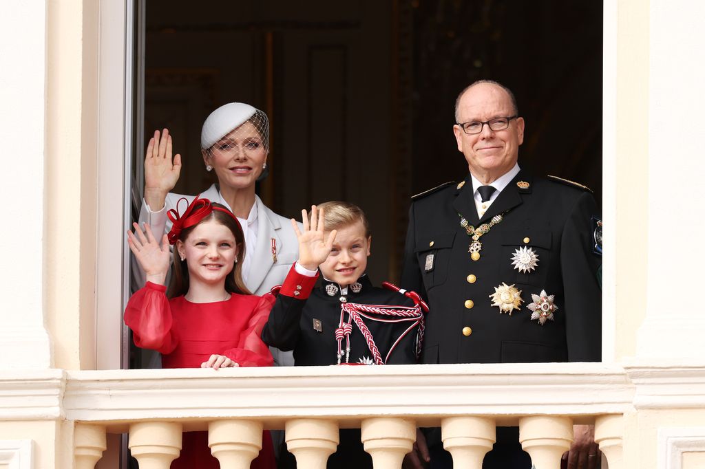Princess Charlene and Prince Albert with children on balcony