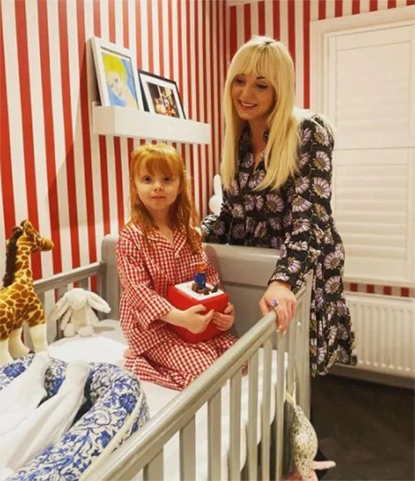 Helen George with daughter in baby's nursery