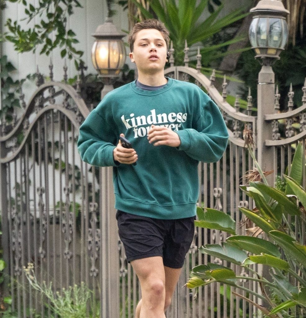 Knox Pitt, the son of Brad Pitt and Angelina Jolie wears Kindness Forever green jersey