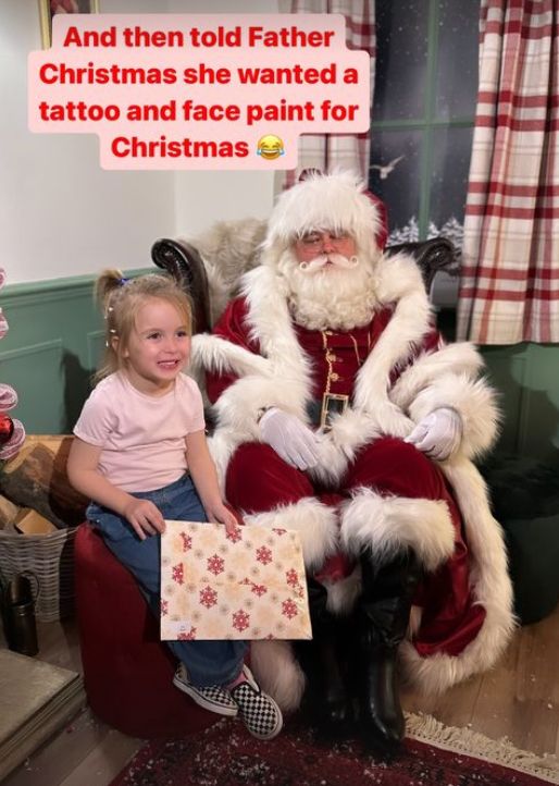A young girl with Santa Claus