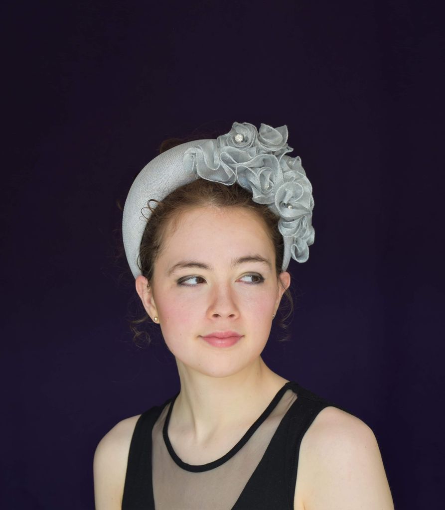 Model wearing grey headband with floral detailing