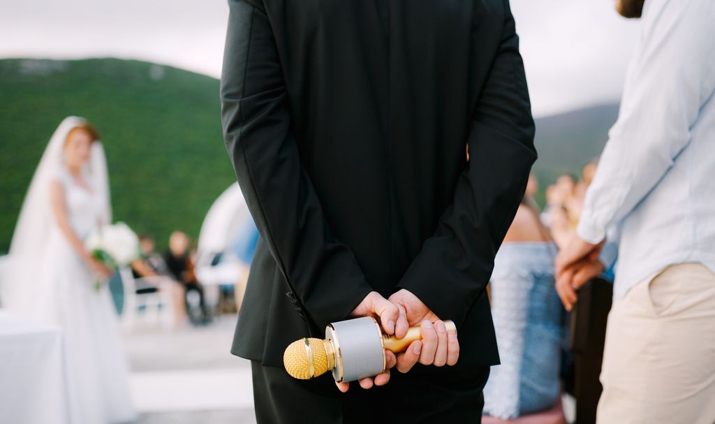 Best man holding a microphone at a wedding