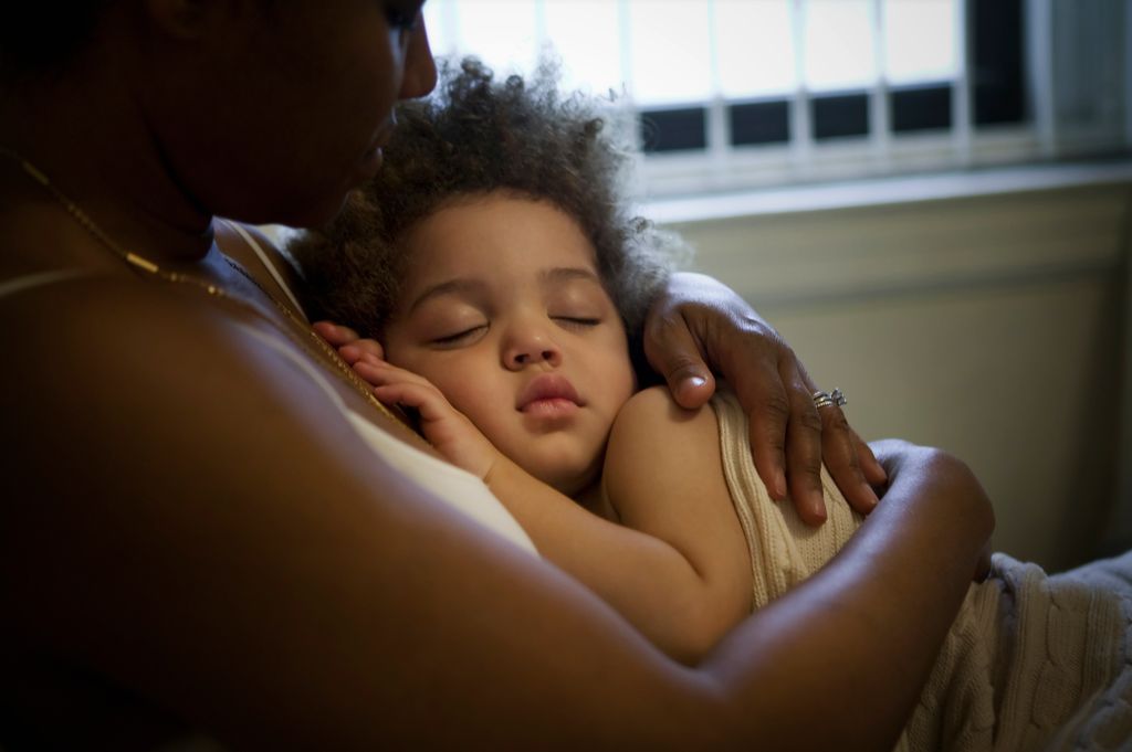 baby in mother's arms wrapped in blanket