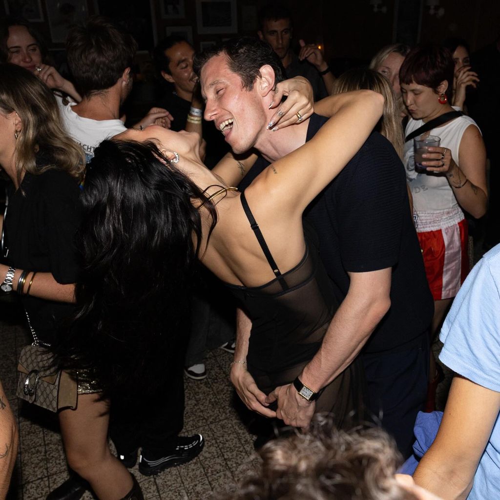 Dua Lipa and Callum Turner dance together, Callum has his hands on Dua's bum