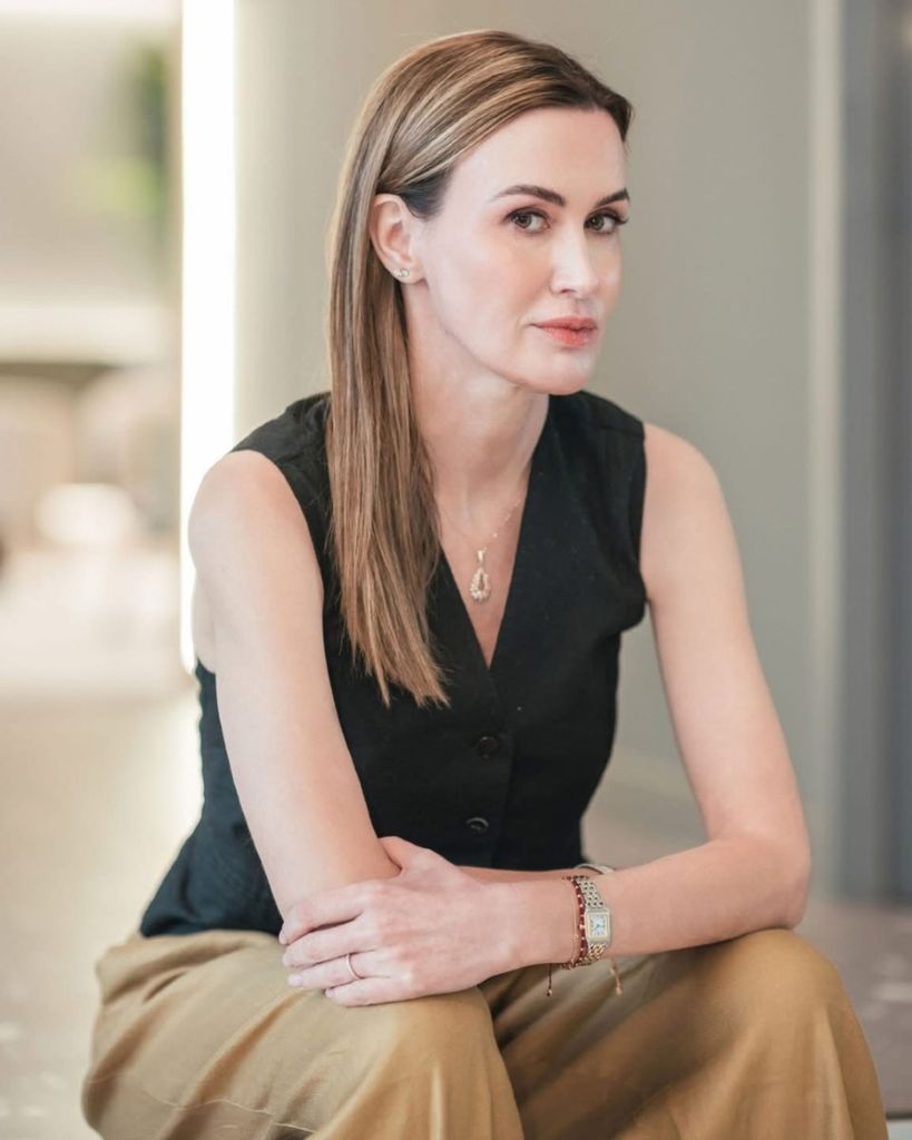 Serious woman in a black top and smart trousers 