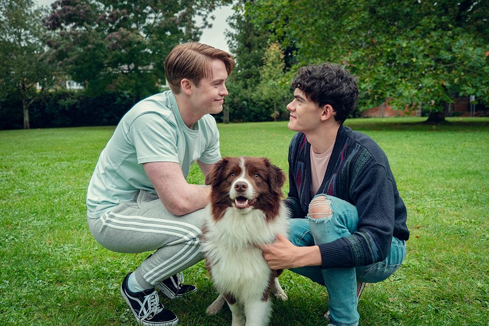 Nick and Charlie staring at each other in a park