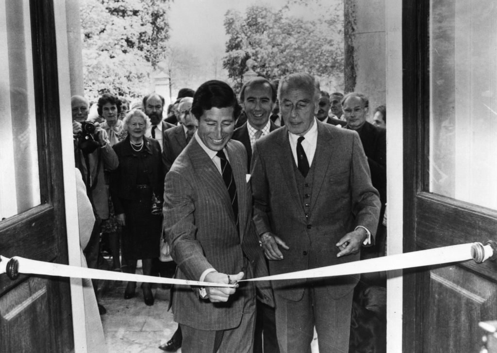 two men cutting a ribbon at opening event 