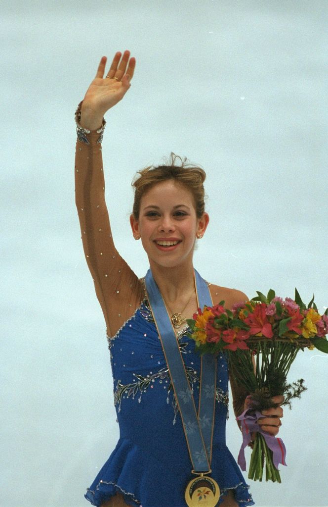 Tara Lipinski of the USA waves with her gold medal at the 1998 Winter Olympic Games