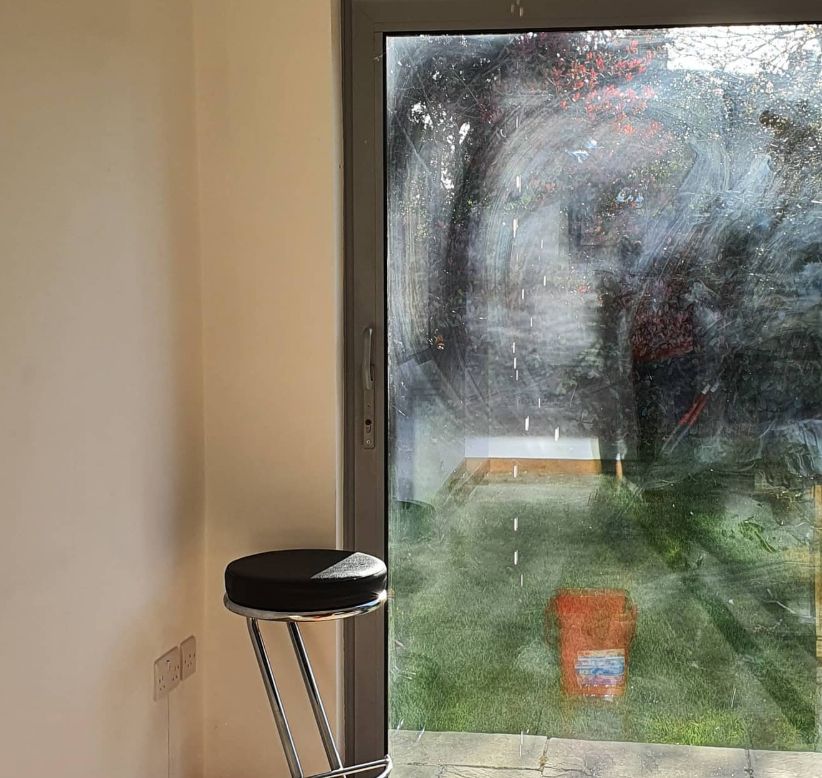 A look of a garden from inside a kitchen