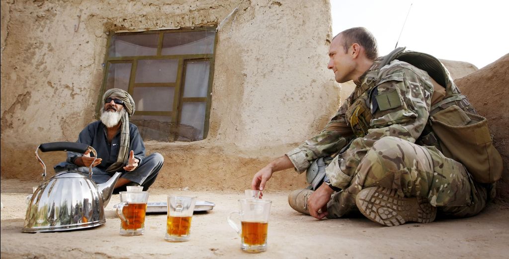 Major Nik Cavill of X-Ray Company, 45 Commando Royal Marines, with a local man in the village of Siadabad, while on patrol from Patrol Base Kalang in Afghanistan. 