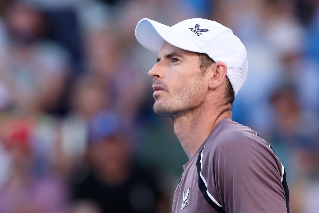 tennis player on court in baseball cap