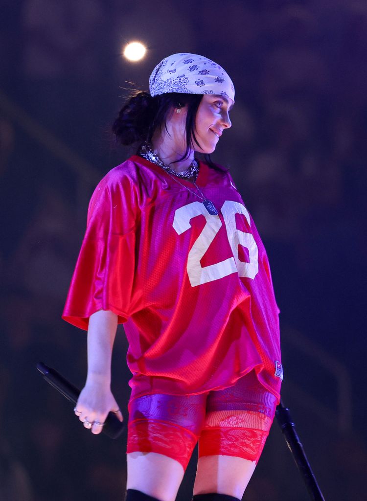 Billie Eilish struts on stage in lacy red shorts as she kicks off new