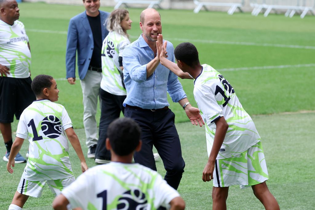 The future King hit the field to participate in a football drill with local children at the stadium. 