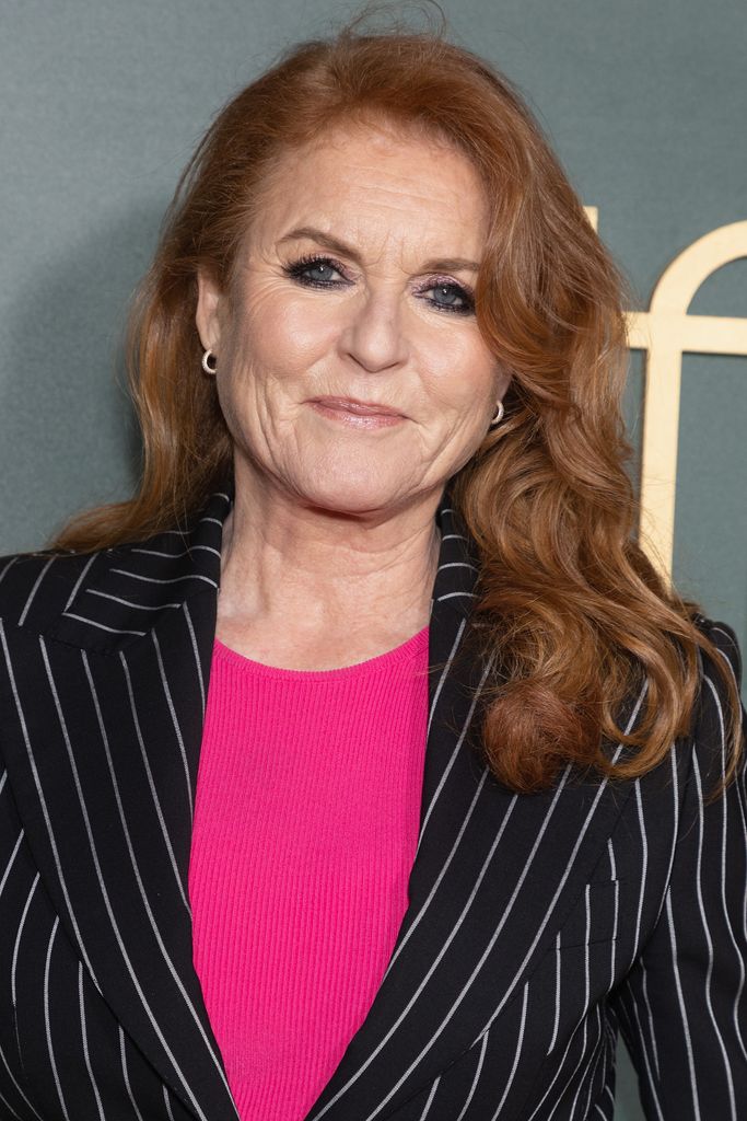 Sarah Ferguson smiling with pink top with curly hair 