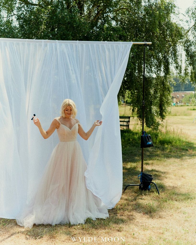 The TV star posed in a garden with the new fragrance