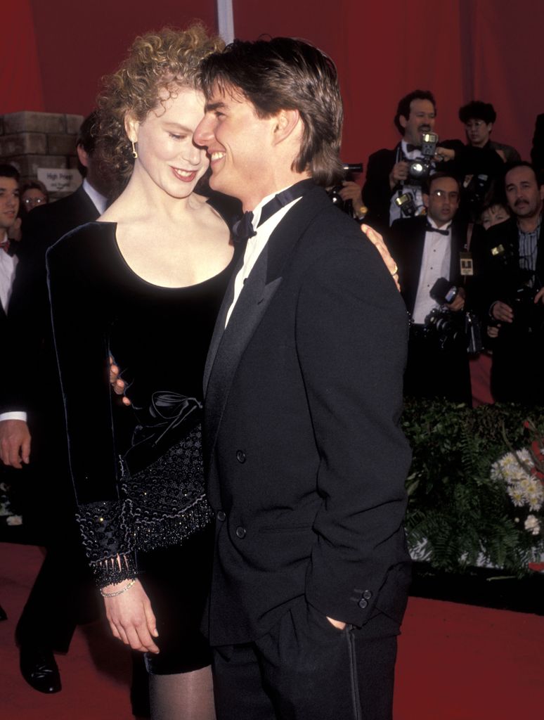 Nicole and Tom in 90s on red carpet in black