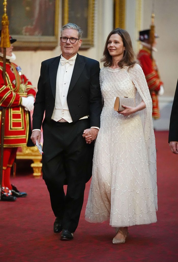 Keir Starmer and wife Victoria walking through Buckingham Palace