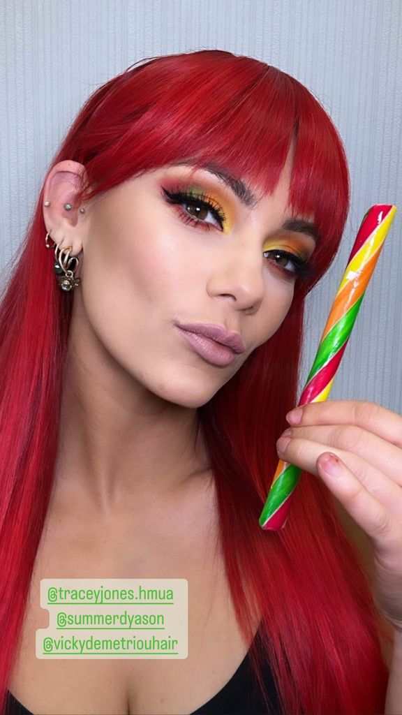 Dianne Buswell posing with a stick of rock