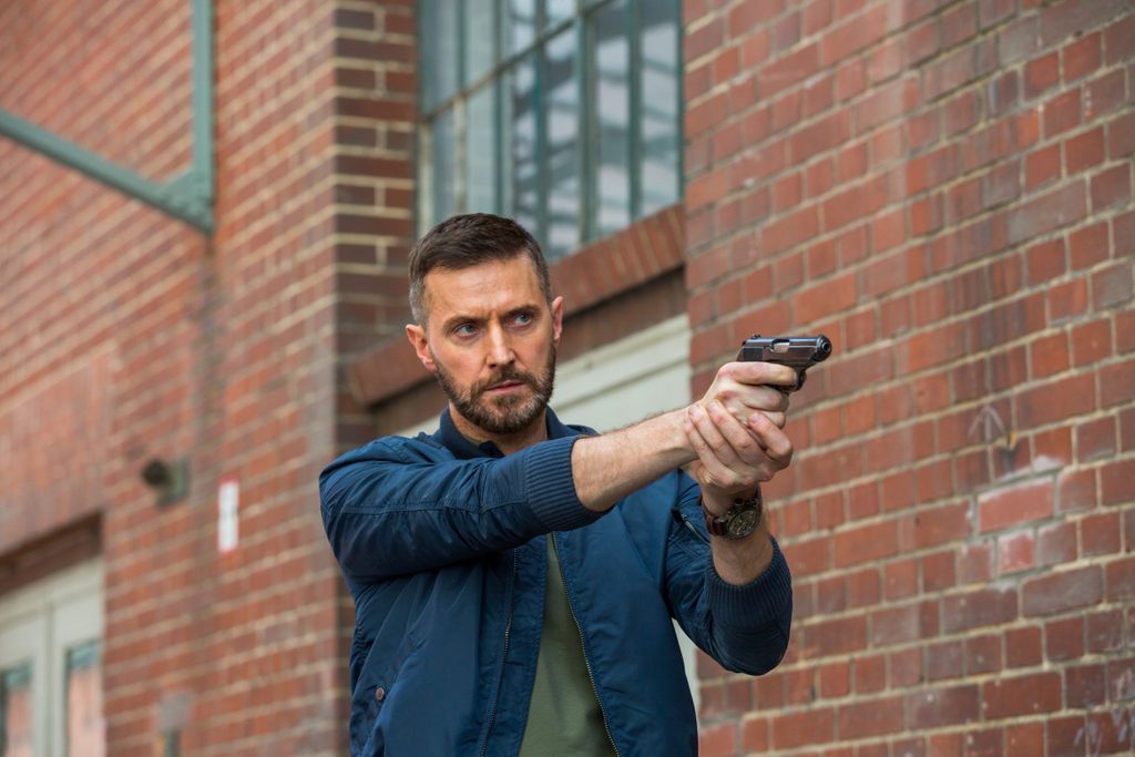 man holding gun pointing it