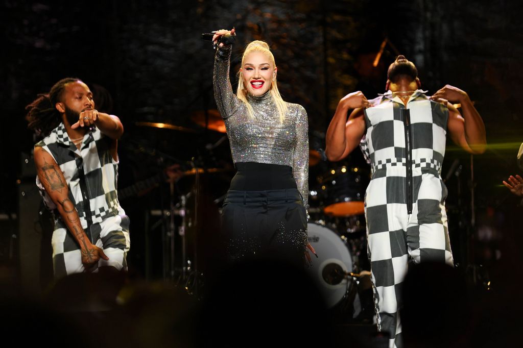 Gwen Stefani performing with two backing dancers