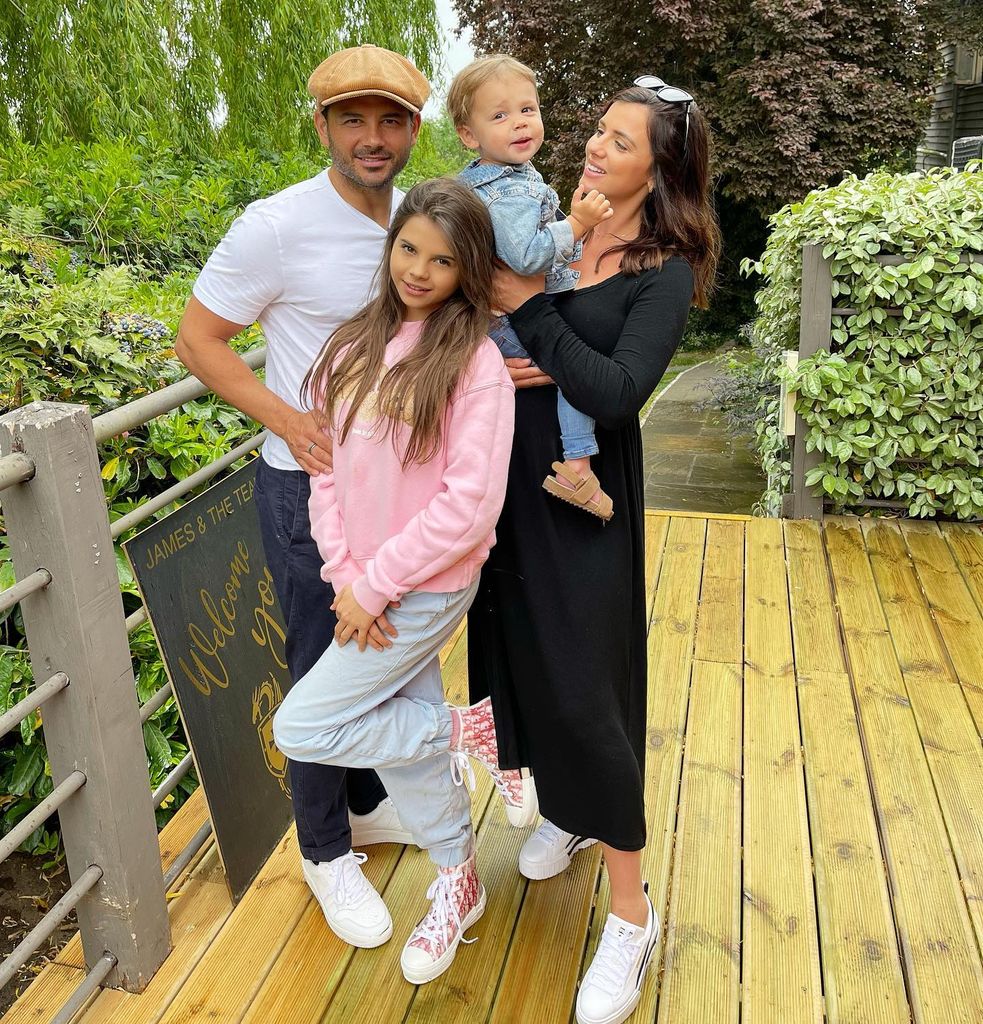 blended family posing on wooden decking