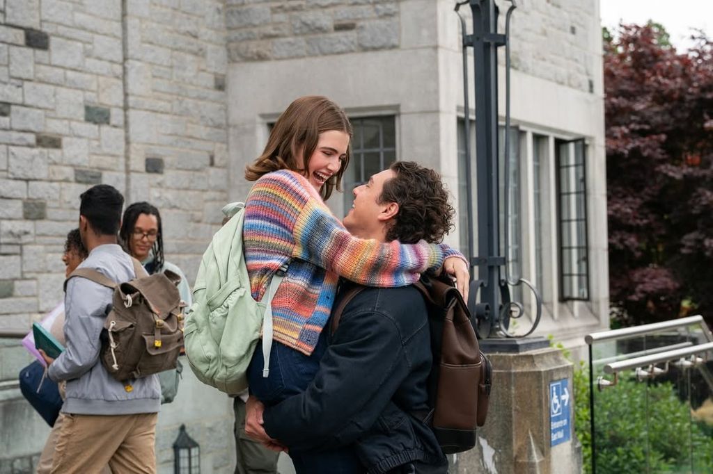 A man holds a woman up in the air 