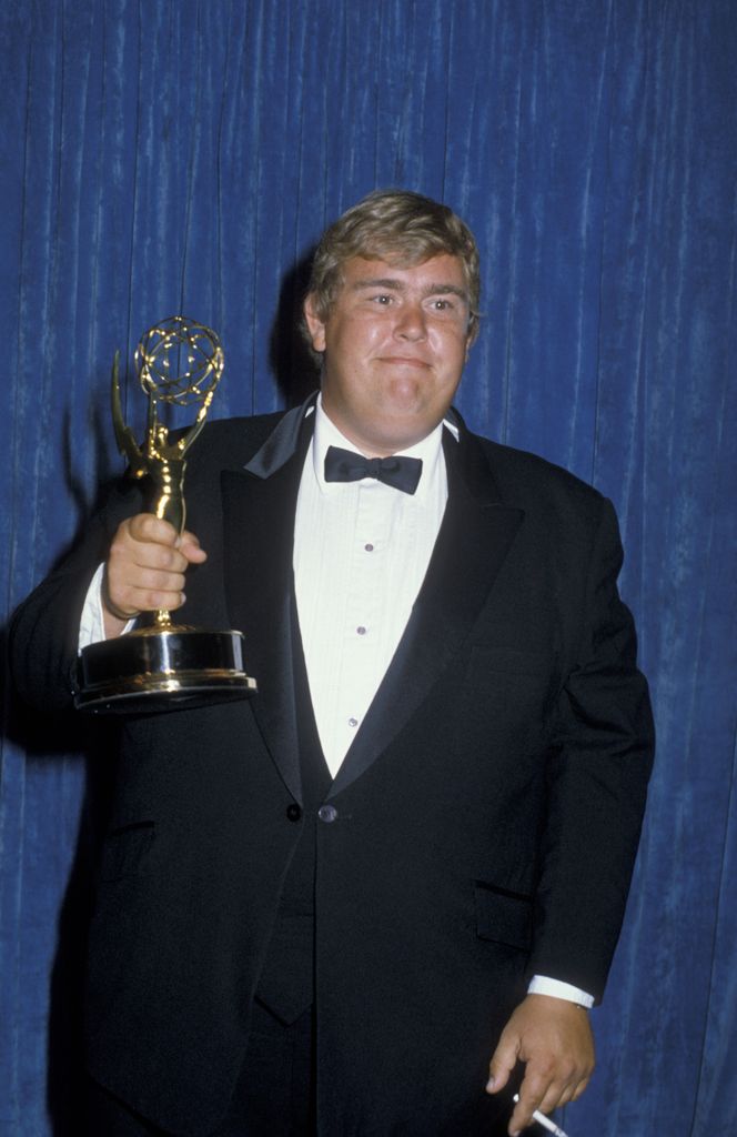 photo of john candy holding an emmy award