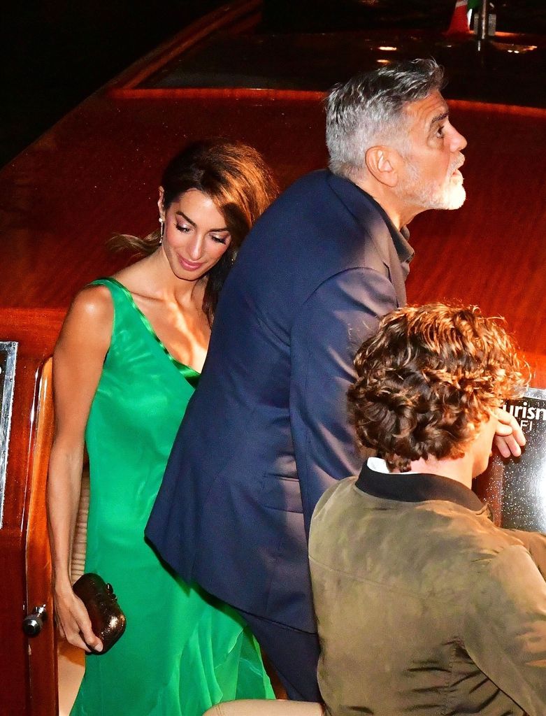 George Clooney with his wife Amal step off a boat in Venice