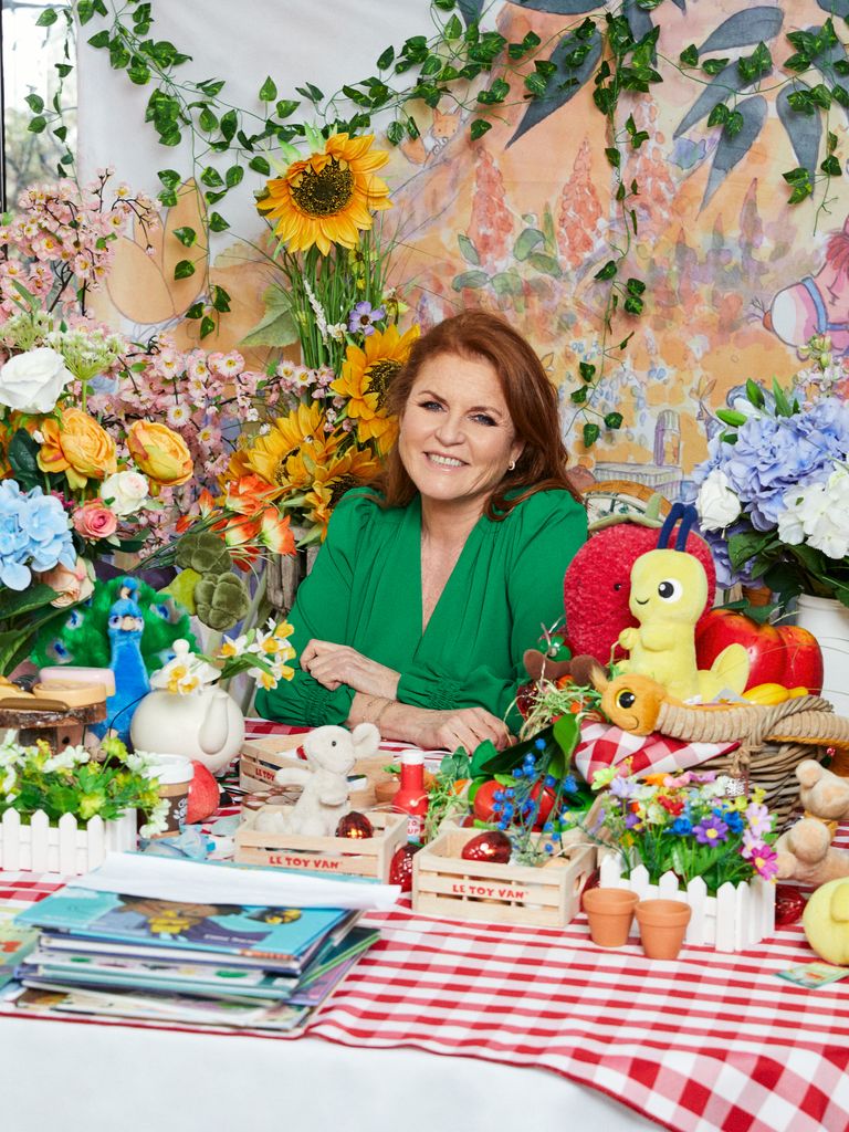 Sarah Ferguson sitting at picnic table with toys and books