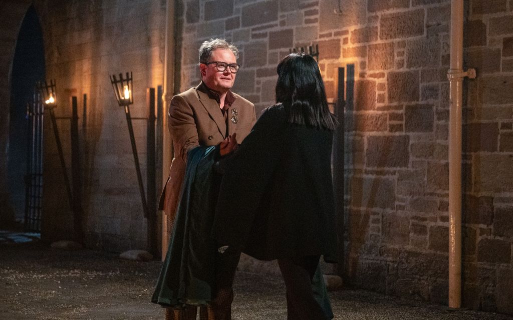 Alan Carr recieving the Traitors cloak from Claudia Winkleman